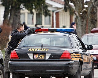 Sheriffs Dept and violent crimes task force and area police agencies with YPD keep watch on the West LaClede house after a report of a car having its tire shot out