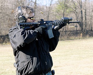 READY, AIM: Lt. Robin Lees, commander of Mahoning Valley Law Enforcement Task Force, fires downrange to help demonstrate the ShotSpotter gunshot location system.