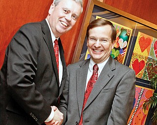 Akron Children's CEO Bill Considine and HMHP CEO Robert Shroder shake hands in the main entrance of Akron Children's Beeghly Campus on Market street in Boardman for the VIP tour of the hospital, Wednesday December 3, 2008