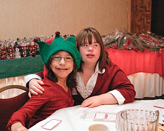 New friends Vanessa Vrabel (11) of Youngstown and Courtney Daniels (17) of Warren take a break from dancing at the annual Winterfest Dance at Mahoning Country Club in Warren, Wednesday December 3, 2008