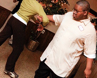 East High helper Aiesha Ethridge (17) dances with fellow East High student Tobias Tilgram (20) at the annual Winterfest Dance at Mahoning Country Club in Warren, Wednesday