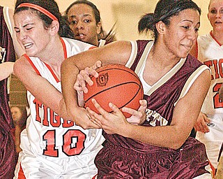 HOWLAND - LIBERTY - (10) Erika Nites of Howland gets tangled up with (11) Melissa Dykes during their game Wednesday night.