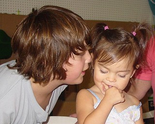 Stefan Russell telling secrets to little sissy Adriana Trafficante on her 2nd birthday. Both of Boardman, Ohio. Picture taken by John Trafficante.