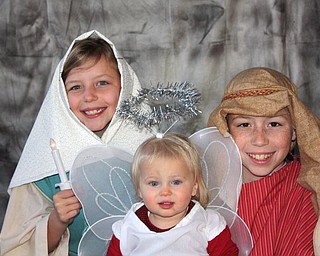 Payton Zwingler (16 months) of Columbiana and her cousins Noah (11) and Grace Cope (8) of Knoxville, Tenn., enjoyed putting on a holiday skit.
Photo submitted by Chad and Alyson Zwingler