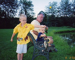 Uncle Jim Theisler shows Mason and Braden a thing or two about fishing at a pond in Coitsville. The boys were visiting from Wisconsin. Photo from Jean Roche of New Middletown.