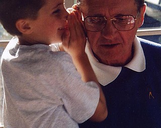 Matthew Di Ianni shares a secret with grandpa Paul McIntire of Youngstown.