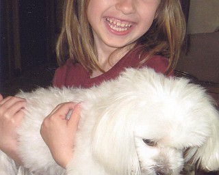 Riley Sweder has some fun with Grandma's dog, Sasha. Photo from Mrs. T. Sweder of Struthers.