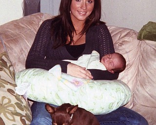 Melinda Holtzman with her first child, Allen Jr. (born Oct. 25), and her chihuahua, Nino. Vicky Hoffman of North Lima was visiting her daughter, Melinda, in Charlotte, N.C.