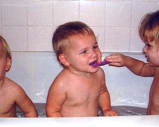 Belyn Bower, 3 1/2, brushes sister Kaelyn's, 1 1/2, teeth ad brother Hadyn, also 1 1/2, waits his turn. Parents are Brandon and Jackie Bower of Austintown.
