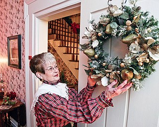 Colette Chuey, Vice Pres. of Girard Historical Society makes prepartions for Christmas at the Barnhisel House event.
