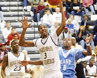 Harding's Desmar Jackson pulls down a rebound past Mark Thornton of East.
