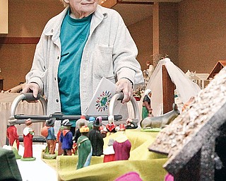INCLUDING HERS: Sister Mary Joana, one of the nun's at the Villa Maria community, admires the display of Nativities, which includes her own, No. 109. The exhibit continues today form noon to 4 p.m., and next Saturday and Sunday.