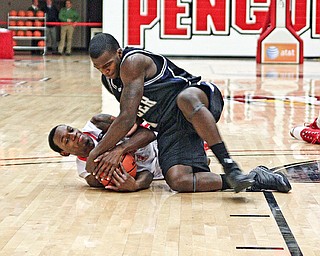 FLOORED: De'Andre Mays of Youngstown State and Butler's Shelvin Mack battle for the ball during Saturday's game at Beeghly Center. The Penguins fell 79-71 to their Horizon League rival.
