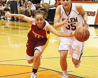 OUT OF REACH: Mooney's Jessica Farragher (11) knocks the ball away from Salem's Amy Scullion (35) during their game Monday night in Salem. The Quakers defeated the Cardinals, 53-38.