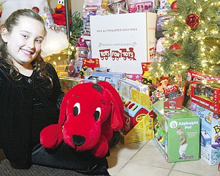 LENDING A HAND: Alexis Cintron, 8, of Austintown, shows off some of the gifts she's collected during her second annual Toys For Tots drive. She said she decided to start her own drive last year and hopes to double the 250 toys she collected in 2007. Toys can be dropped off at Spalon in Howland through Dec. 17.