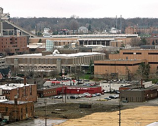 SPRAWLING CAMPUS: In conjunction with the new $34.3 million Youngstown State University business school to be built on the vacant land in the foreground, the city seeks to seize and demolish the small brown brick machine shop at 128 W. Rayen Ave., which has a brown garage door, for a proposed Hazel Street extension, which would curve around the Diocese of Youngstown office at bottom left.