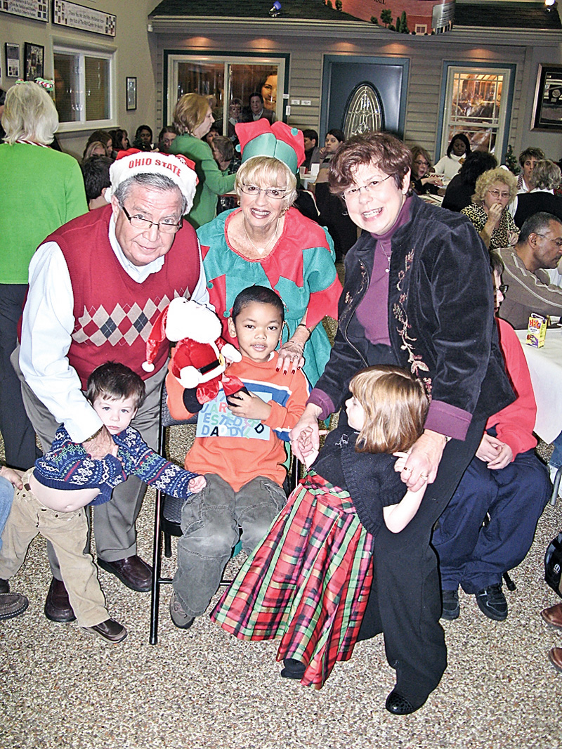 FOR THE KIDS: Children, parents and staff of The Rich Center for Autism enjoy food, music and seasonal fun at the third annual holiday party sponsored by Merv and Marlene Hollaner. Merv Hollander, his wife, Marlene, and Bernadette Kovach share in the fun with center pupils, from left, Colin Brogan, Nathan Tucker and Ellie Brogan.