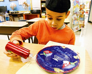 Alexander Smith - third grader at Akiva - finishes putting glitter on his chanuka plate he made in glass