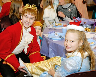 Claire Toth, 7 1/2 of Pulaski, PA tries on the glass slipper with a little help from The Prince "Matt Stevens" during the Cinderella brunch held at the Trinity United Methodist Church in Youngstown on Saturday.