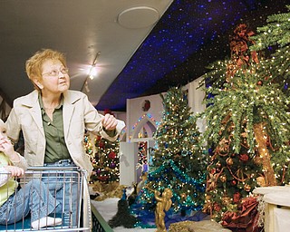 Mary Ellen Boomhower pushes her grandaughter, Hannah Zagotti (age 1) through Kranyak's Christmas display in Hermitage. "I brought my kids here when they were little," says Boomhower, "Its a real treat to bring the little-er ones." "This is my gift to see all this," says Boomhower who was blind for eleven years before a surgery 19 years ago brought her eyesight back, "it surely is." Diabetes once robbed the grandmother of her sight and the illness continues to threaten her as she waits for a kidney transplant.
