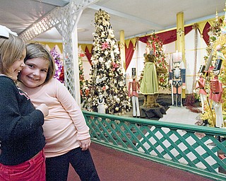 Meredith Lauther gets a hug from her cousin, Lexi Tonty, both 4 year old residents of Sharpsville, while viewing the displays at Kraynaks in Hermitage, PA. "This is where we come after pre-school," says Lauther's grandma, Linda Hazi, "we've been here at least ten times this year."