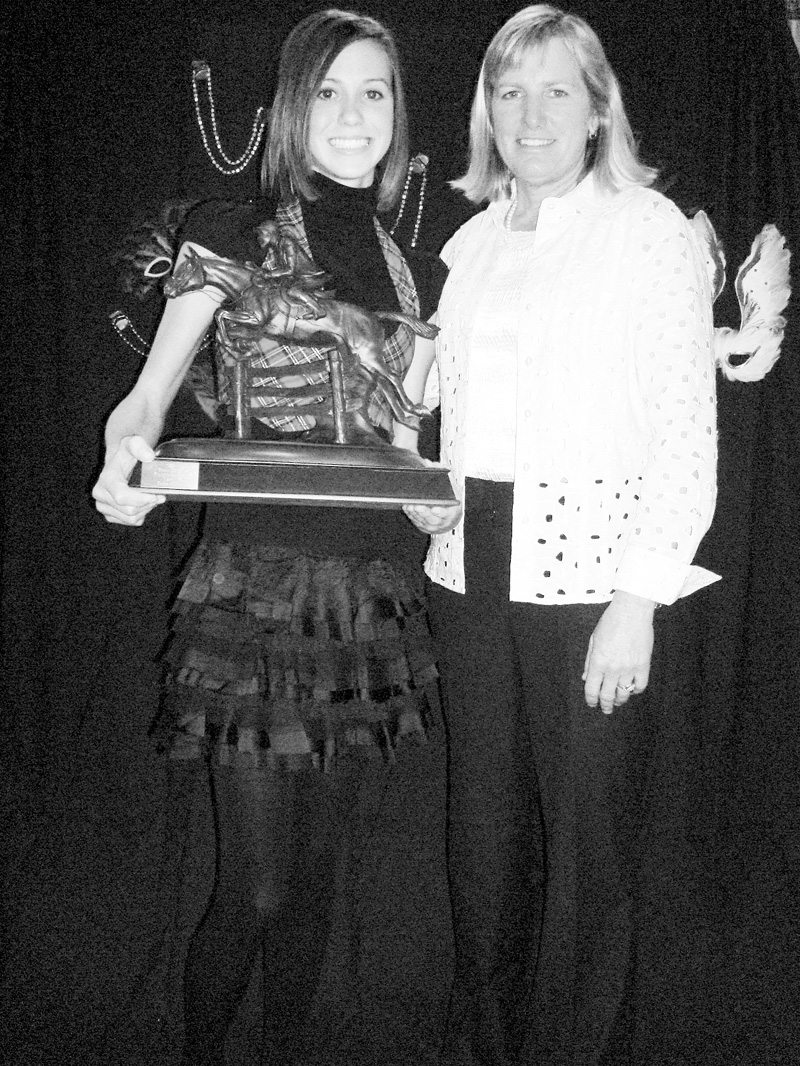Gina Malito of Howland poses with Karen O'Connor, a U.S. Olympian in equestrian events. Malito is holding the trophy that will bear her name and the name of the pony she rode while winning first place in her division of events sponsored by the United States Eventing Association. Malito and her pony won two national awards for their performances in 2008.
