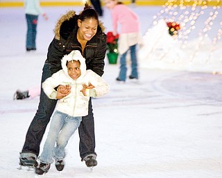 Latia Ballard, of Austintown, helps Tierni Ballard, age 4, ice skate for the first time during Holiday Ice Skating at Chevy Centre.