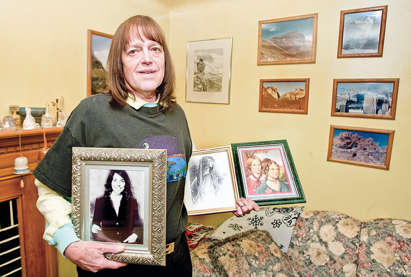 Phillip Lyle displays images of his musical and literary inspirations,  (left-right) Karen Carpenter, in addition to Anne, Emily, and Charlotte Brontë, in his Youngstown home. Lyle recently became a member of Mensa.