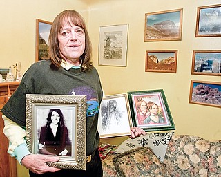 Phillip Lyle displays images of his musical and literary inspirations, (left-right) Karen Carpenter, in addition to Anne, Emily, and Charlotte Brontë, in his Youngstown home. Lyle recently became a member of Mensa.