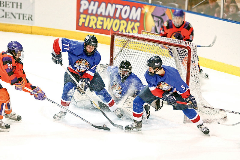 Phantoms Cole Schneider (24) gets blocked from making a goal by Andy Yarber (77), Goalie Nick Graves (30) and Ryan Sell (5) Sunday December 28, 2008
