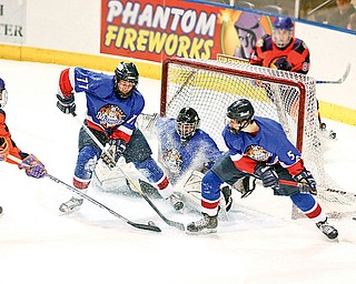 Phantoms Cole Schneider (24) gets blocked from making a goal by Andy Yarber (77), Goalie Nick Graves (30) and Ryan Sell (5) Sunday December 28, 2008