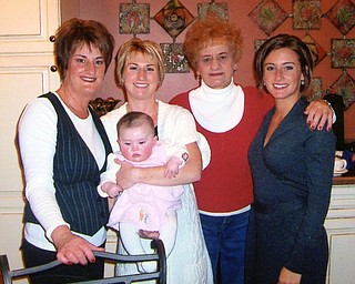 For Debbie Walcott of Youngstown, joy is having extended family together for Christmas Eve. Lee Houser of Boardman is surrounded by her daughter, Walcott, and two granddaughters, Jessica Krauser of Columbus and Tricia Lenhart of Boardman, along with great granddaughter Samantha Rae.