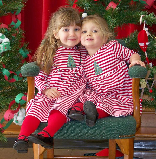 Madison Kelso (left) and Mackenzie Kelso (right) sit in Santas chair as they wait for him to tell them what they're getting for Christmas. Sent by granddad, Peter Gabriel. Mom is Lisa Kelso.