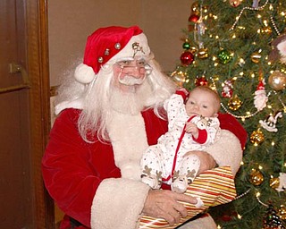 5 month old Ella Rose Solak sits on Santa's Lap on Christmas Eve at the Menichini Family Christmas Party in Lowellville
photo submitted by Jodi Coppola