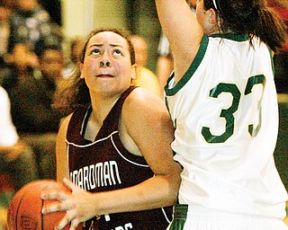 SHOOTS FOR TWO: boardman High's Erin Brown, left, goes up for a shot as Ursuline's Chase Connors defends in the first half of Monday's girls basketball game. The Spartans won the game, 51-38.