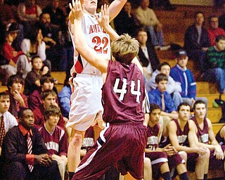 BIG NIGHT: Canfield's Casey Carroll releases a shot over the head of a Boardman defender Ken Johnson during Tuesday's game in Canfield. The Cardinal junior had a career-high 28 points in Canfield's 72-53 win over the Spartans.