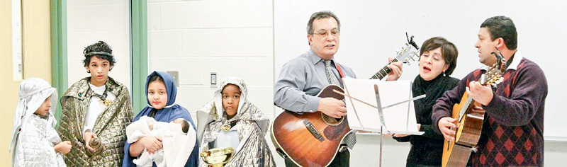 Abraham Jiminez, Luiz Velazquez, Jesynette Morales and Justin Smith dress up while Luis Arroyo, Grimilda Ocasio and Efrain Ruano sing for Williamson Elementary School's annual Three Kings Day celebration Wednesday 