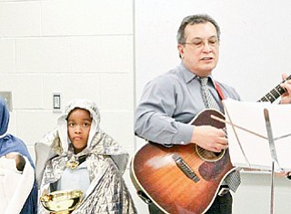 Abraham Jiminez, Luiz Velazquez, Jesynette Morales and Justin Smith dress up while Luis Arroyo, Grimilda Ocasio and Efrain Ruano sing for Williamson Elementary School's annual Three Kings Day celebration Wednesday