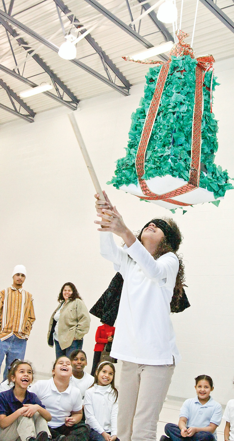 Fifth grader Coralys Fontanes at Williamson Elementary School tries to break the pinata as part of the annual Three Kings Day celebration Wednesday January 7, 2008