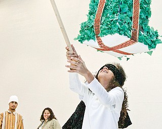 Fifth grader Coralys Fontanes at Williamson Elementary School tries to break the pinata as part of the annual Three Kings Day celebration Wednesday January 7, 2008