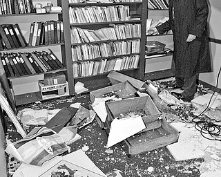 DRAMATIC DESTRUCTION: Rand Becker, president of the Youngstown PLayhouse executive board, examines the damage down to one of the theater's rooms after a pipe burst last month. The theater needs an estimated $800,000 worth of work, Becker said.