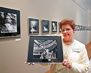 Norma Roden, special events coordinator at Mill Creek Parks' Fellowside Riverside Gardens, shows off a photograph of Ernest Vickers, the park's first naturalist. Vickers' black-and-white photos are on display at the gardens' D.D. and Velma Davis Education and Visitor Center in "Ernest Vickers Retrospective." VIckers, also a botanist, took photographic images from the late-19th centuries that feature well-known park landmarks and nature scenes.