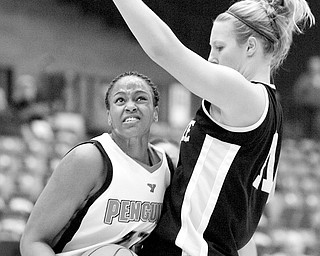 YSU's #21, Tiara Scott makes her way down the court as Milwauke's #11 Lindsay Laur tries to block during a matchup between the two at YSU's Beeghley Center, Thursday night.