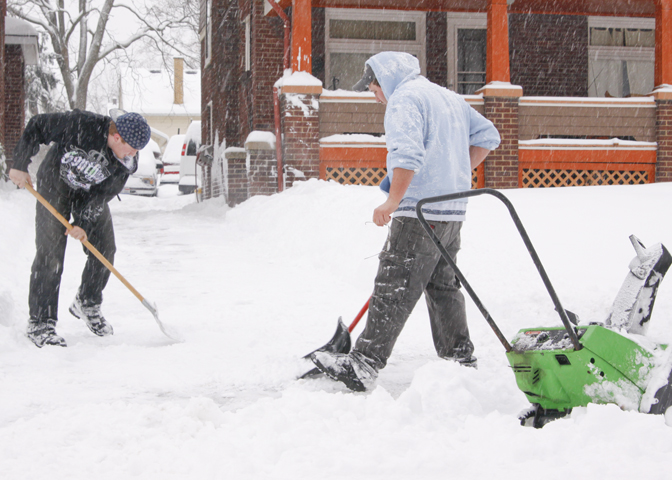 Chris Inskeep (18) of Hubbard and Ryan Foltz (25) of Hubbard shovel and plow Inskeep's grandmother's driveway in Youngstown, Saturday January 10, 2009