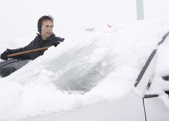 Sales and Leasing Executive Rodney Stanko of Niles cleans off cars in the lot at Greenwood Chevrolet in Austintown, Saturday January 10, 2009