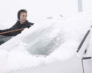 Sales and Leasing Executive Rodney Stanko of Niles cleans off cars in the lot at Greenwood Chevrolet in Austintown, Saturday January 10, 2009