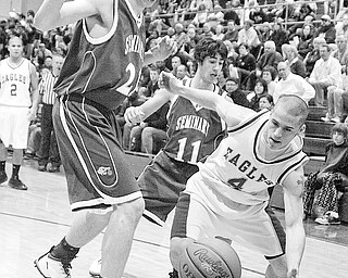 POLAND - HUBBARD - (4)Sam Bellino of Hubbard tries to save the ball as (21) David Baker and (11) Dom DeFelice play defense during their game Friday night in Hubbard.