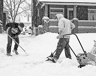 Chris Inskeep (18) of Hubbard and Ryan Foltz (25) of Hubbard shovel and plow Inskeep's grandmother's driveway in Youngstown, Saturday January 10, 2009