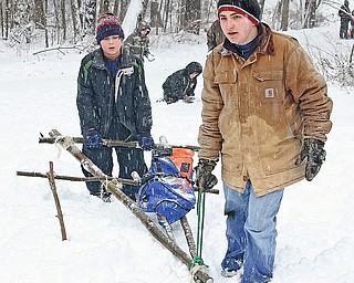 BOY SCOUT - (FRONT) Edward T. and Tim L. bring their sled up the hill Saturday afternoon.
