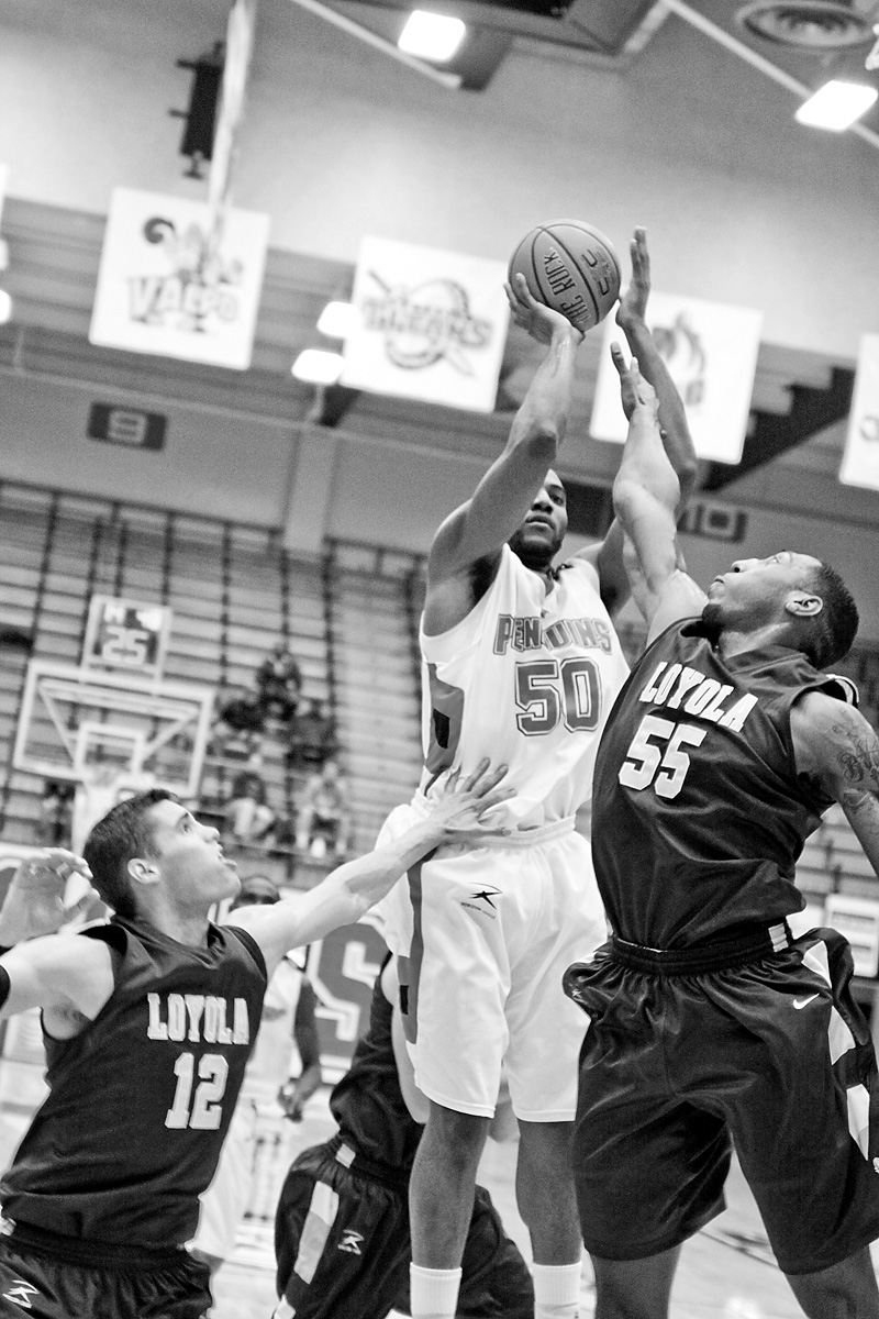 YSU Jack Liles (50) gets blocked by Loyola's Aric Van Weelden (12) and Darrin Williams (55)  Saturday January 10, 2009